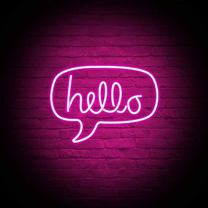 brick wall with a neon hello speech bubble